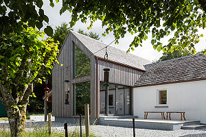 Double-height extension to stone house in Lochaber with larch cladding