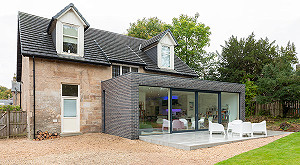 Side view of brick glazed extension to sandstone Victorian house in Bearsden